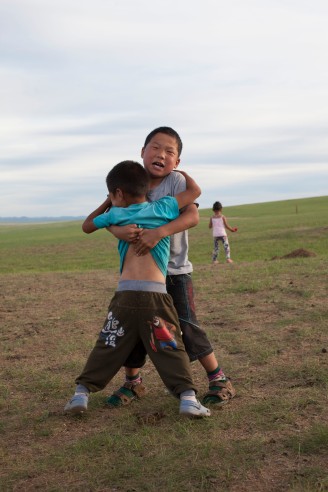 Play-wrestling with a friend. Wrestling and horseriding are both very appreciated sports in Mongolia.